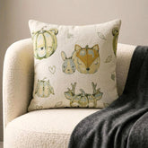 Fall Halloween home decor pillow cover, A woven jacquard throw pillow cover with pumpkin fox design and subtle fall colors for Autumn Decor set on a grey chair with a black throw and layered with an orange velvet pillow cover. Decorated with a tray containing maple leaves, pumpkin, book, and fall colored flowers, creating a perfect, cozy, and comfortable fall decor setting. Handcrafted pillow cover from The HomeCentric's Fall Collection.