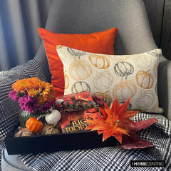 Orange woven jacquard pumpkin pattern lumbar pillow cover for Halloween & Fall home decor. Ideal for modern or country style home decor, the oblong cushion cover is set on a grey chair paired with a solid orange velvet throw pillow cover from The HomeCentric. A tray is place with the pillows on chair with maple leaves, burlap pumpkins and flower arrangement in fall hues. The look is finished with a black and white monochrome checkered throw. Explore more of fall & Halloween Collection by The HomeCentric!