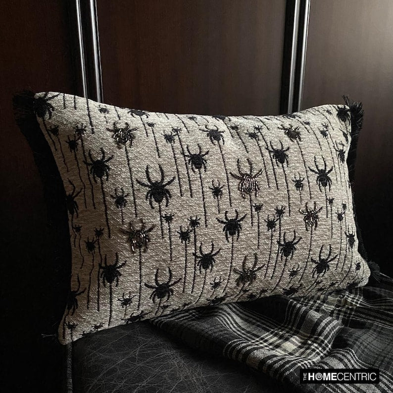 Close-up of Halloween woven jacquard spider oblong cushion cover with intricate embroidery in black and ivory hues.