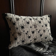 Close-up of Halloween woven jacquard spider oblong cushion cover with intricate embroidery in black and ivory hues.