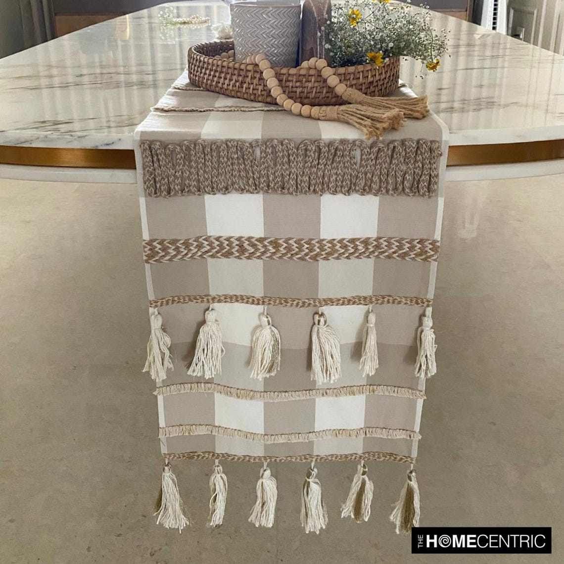 Buffalo check table runner styled with neutral dining decor and ceramic tableware