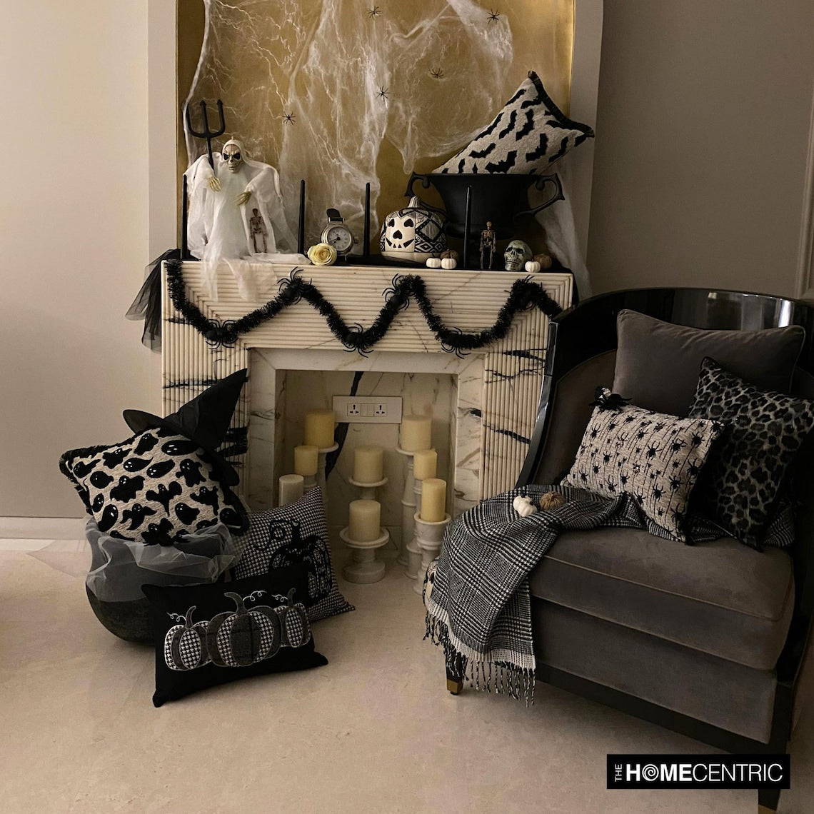 Cozy Halloween-themed sofa with multiple decorative pillow covers designed around the Halloween decor theme  including bats, spiders, witch cats and pumpkin patterns in a spooky Halloween setup with spider web and pumpkins.