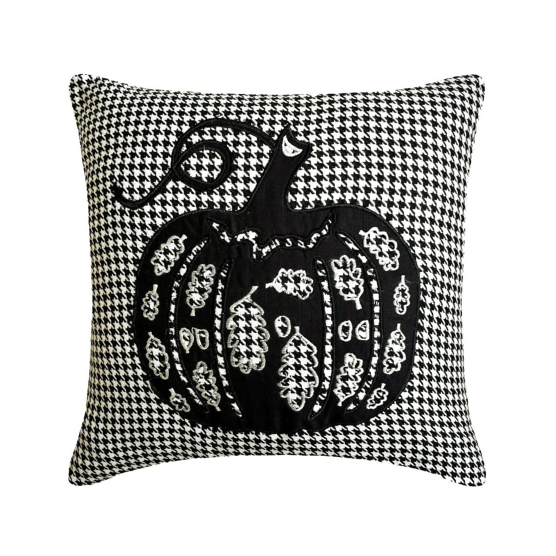 Halloween fireplace corner decorated with various spooky themed pillow covers including ghost, bats, spiders and pumpkin designs. Decorated with Halloween fireplace decor with witch pot and a witch hat, with scary Halloween ghost, black candles and tiny skulls and pumpkins. 