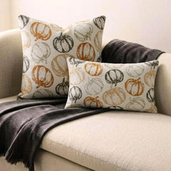 Orange woven jacquard pumpkin pattern lumbar pillow cover for Halloween & Fall home decor. Ideal for modern or country style home decor, the oblong cushion cover is set on a grey chair paired with a solid orange velvet throw pillow cover from The HomeCentric. A tray is place with the pillows on chair with maple leaves, burlap pumpkins and flower arrangement in fall hues. The look is finished with a black and white monochrome checkered throw. Explore more of fall & Halloween Collection by The HomeCentric!