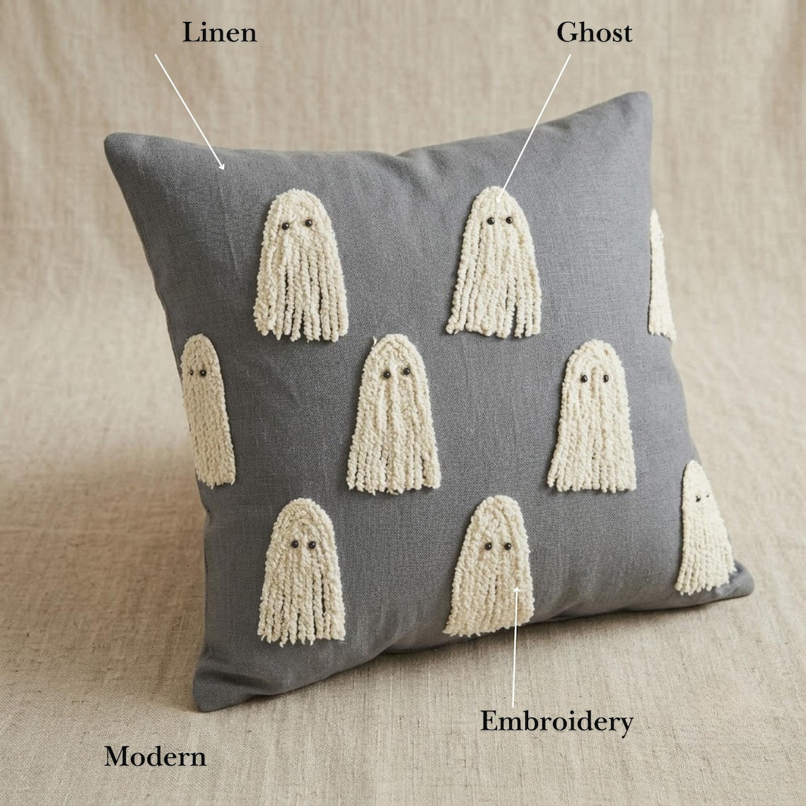 Cozy Halloween decorative pillow covers display with various spooky, haunting and scary Halloween themed placed in a cozy setting with pumpkin decor and spider web.