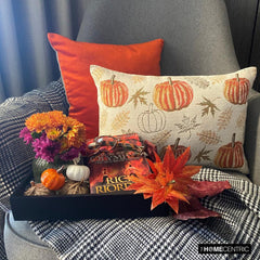 Orange, beige & ivory color pumpkin pattern with maple leaves lumbar pillow cover crafted on a woven jacquard fabric for fall & Halloween decor from The HomeCentric's autumn decor collection. The oblong cushion cover is set on a swing for a cozy autumn corner, beautifully set with fall theme pillows and a black & white throw, a tray with candle, maple leaves, & few burlap pumpkins. Creating a cozy and inviting autumn corner for peaceful moments during the season.  