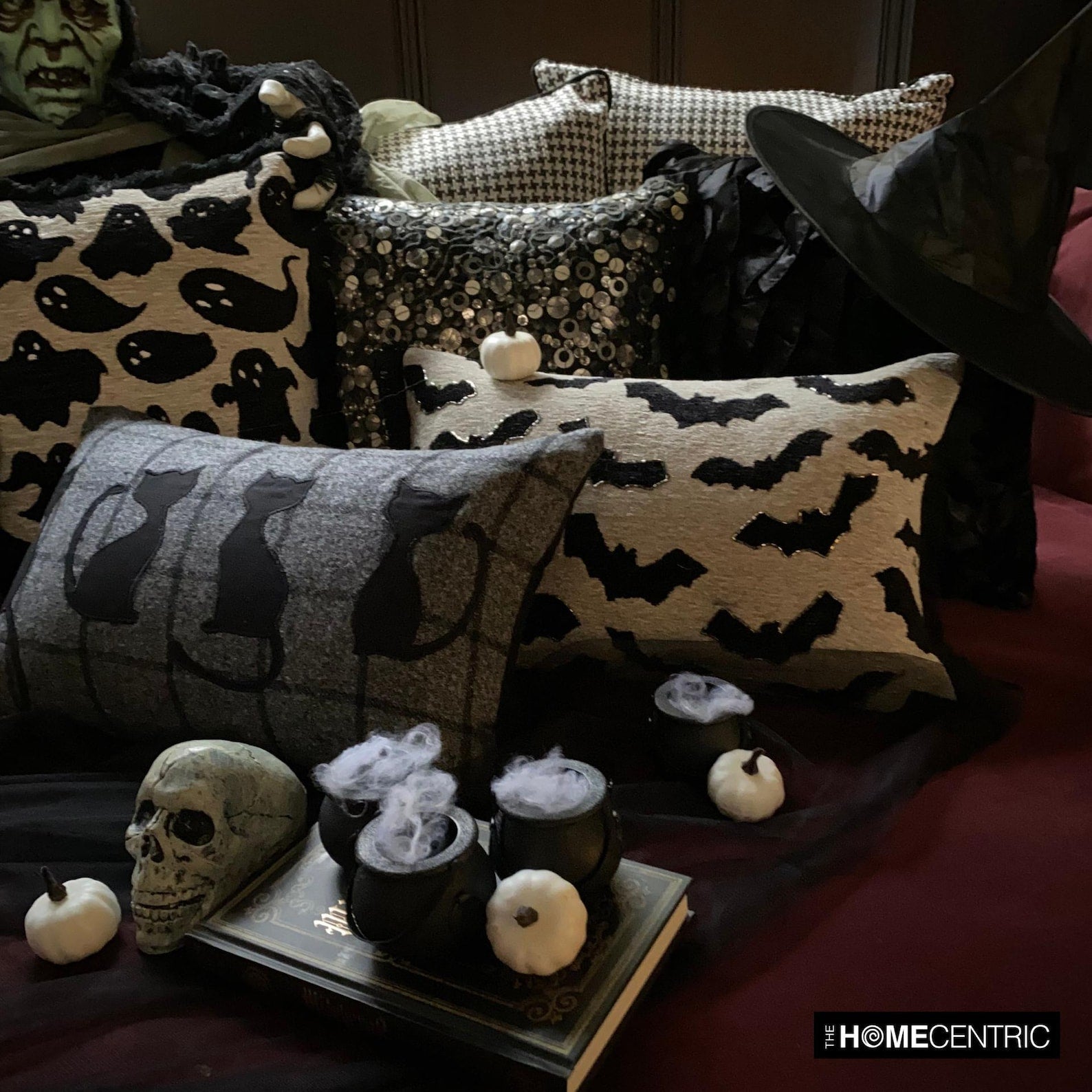 Plaid pillow with black cat designs, perfect for Halloween home decoration