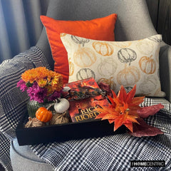 Orange woven jacquard pumpkin pattern lumbar pillow cover for Halloween & Fall home decor. Ideal for modern or country style home decor, the oblong cushion cover is set on a grey chair paired with a solid orange velvet throw pillow cover from The HomeCentric. A tray is place with the pillows on chair with maple leaves, burlap pumpkins and flower arrangement in fall hues. The look is finished with a black and white monochrome checkered throw. Explore more of fall & Halloween Collection by The HomeCentric!