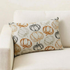 Orange woven jacquard pumpkin pattern lumbar pillow cover for Halloween & Fall home decor. Ideal for modern or country style home decor, the oblong cushion cover is set on a grey chair paired with a solid orange velvet throw pillow cover from The HomeCentric. A tray is place with the pillows on chair with maple leaves, burlap pumpkins and flower arrangement in fall hues. The look is finished with a black and white monochrome checkered throw. Explore more of fall & Halloween Collection by The HomeCentric!