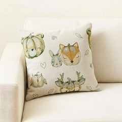 Fall Halloween home decor pillow cover, A woven jacquard throw pillow cover with pumpkin fox design and subtle fall colors for Autumn Decor set on a grey chair with a black throw and layered with an orange velvet pillow cover. Decorated with a tray containing maple leaves, pumpkin, book, and fall colored flowers, creating a perfect, cozy, and comfortable fall decor setting. Handcrafted pillow cover from The HomeCentric's Fall Collection.