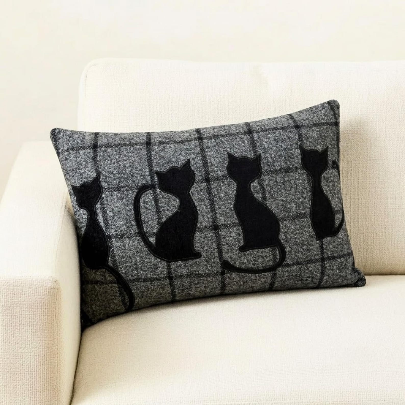 Halloween pillows stacked together, including a black cat design pillow, with a 'trick or treat' pillow and a spider-themed pillow